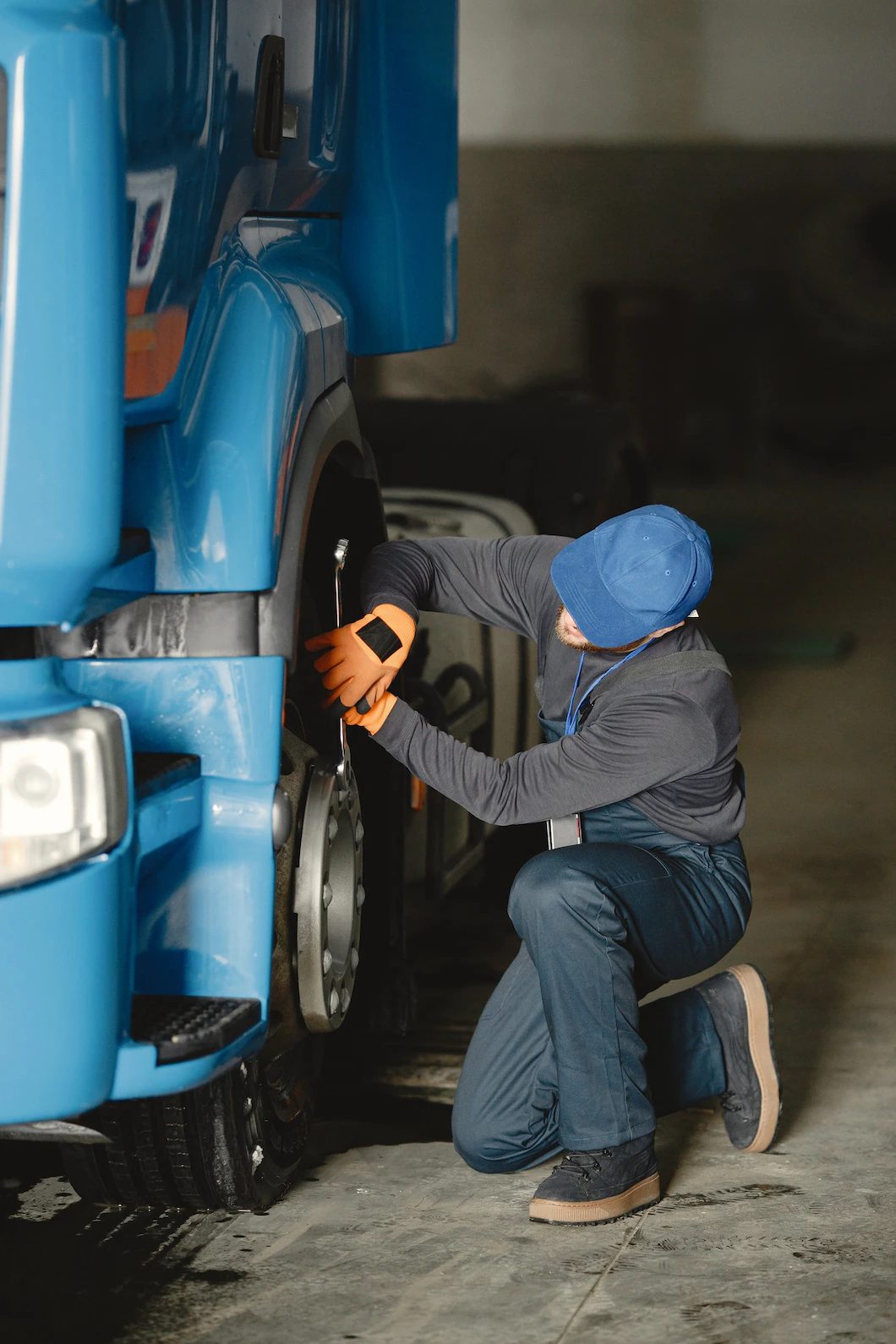 young-worker-checks-wheel-truck-malfunction-service-work_1157-46511